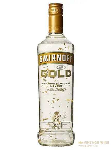 Chai Smirnoff Gold nhãn vàng ghi Cinnamon Flavoured Liqueur, vảy vàng lơ lửng trong rượu